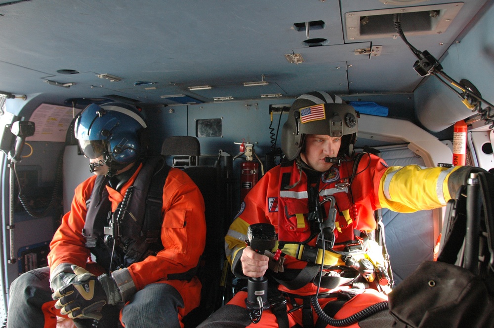 Coast Guard MH-60 Jayhawk helicopter crew performs their duties on a training flight from Sitka, Alaska