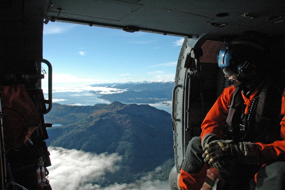 An aviation maintenance technician from Air Station Sitka, performs his duties aboard a Coast Guard MH-60 Jayhawk helicopter