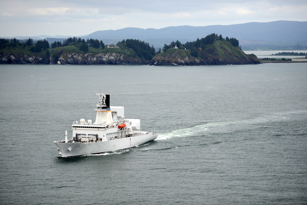 The crew of the USNS Howard O. Lorenzen (T-AGM-25) departs the Columbia River