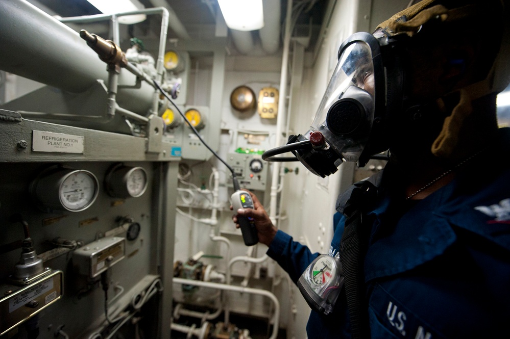 USS Arleigh Burke sailor checks machinery