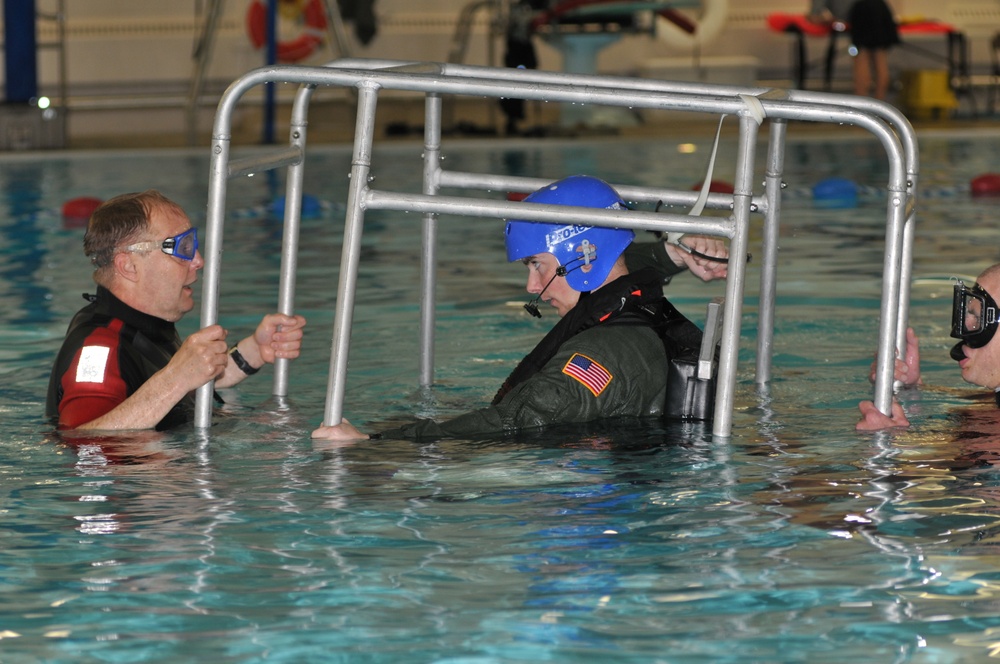 Pilots receive water evacuation training from Coast Guard rescue swimmers