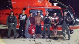 Coast Guard rescues 2 men, 1 child from sinking boat