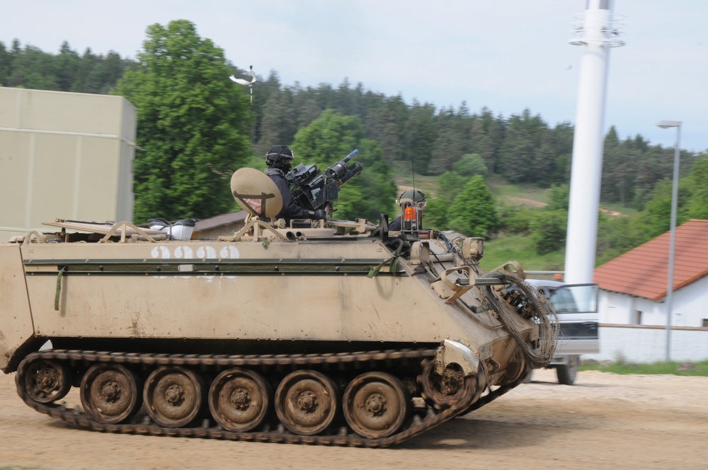 OPFOR armored personnel carrier rumbles into town
