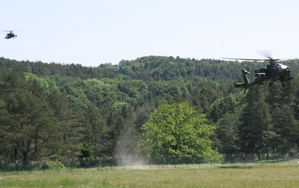 Two Apache helicopters approach airfield