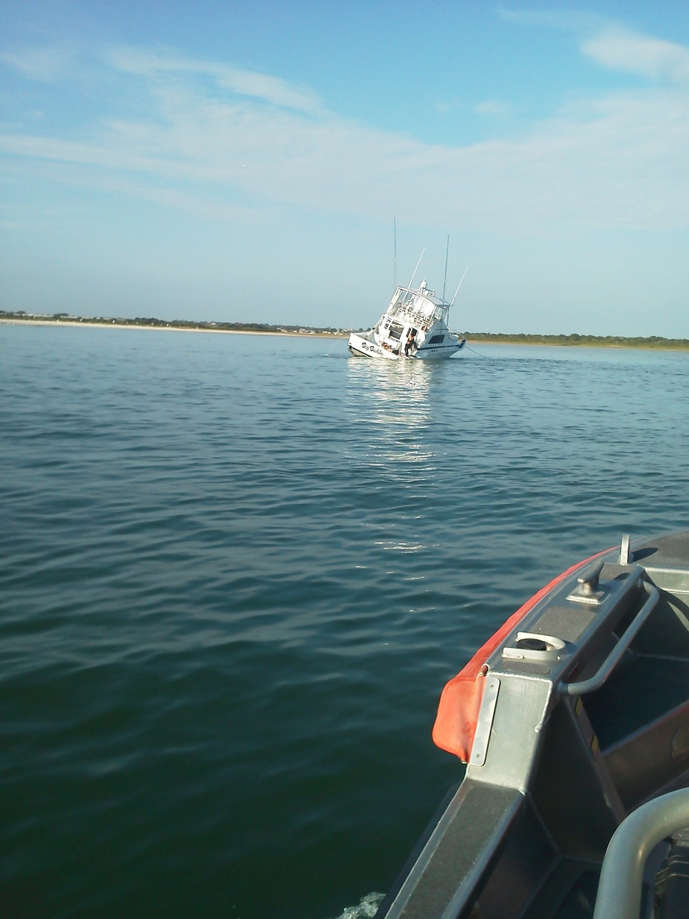 Coast Guard responds to grounded, flooding boat with 7 people aboard