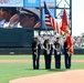 Service members salute the flag during the national anthem on Memorial Day