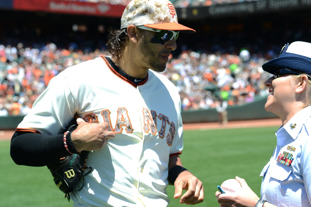 Petty Officer 1st Class Daniell Lashbrook receives an autograph from San Francisco Giants player Michael Morse on Memorial Day