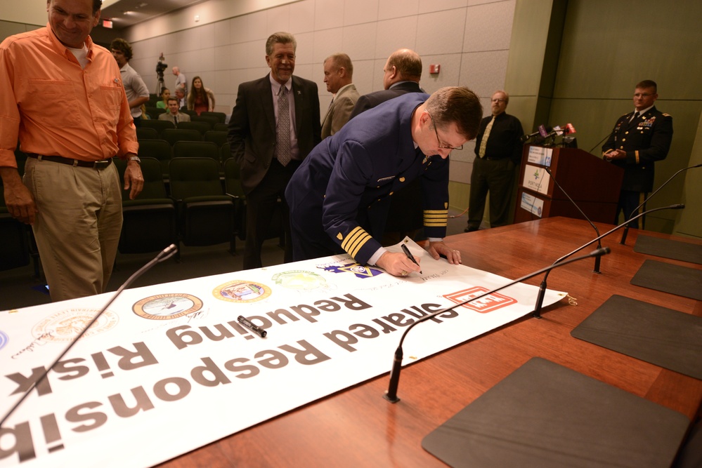 Coast Guard signs partnership banner