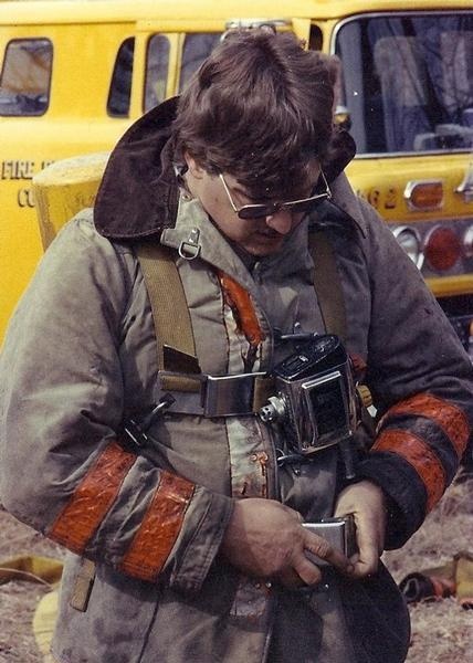 Volunteer firefighter John McDonald makes final adjustments to a self-contained breathing apparatus (SCBA) before entering a fire scenario in the 1970s.