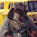 Volunteer firefighter John McDonald makes final adjustments to a self-contained breathing apparatus (SCBA) before entering a fire scenario in the 1970s.