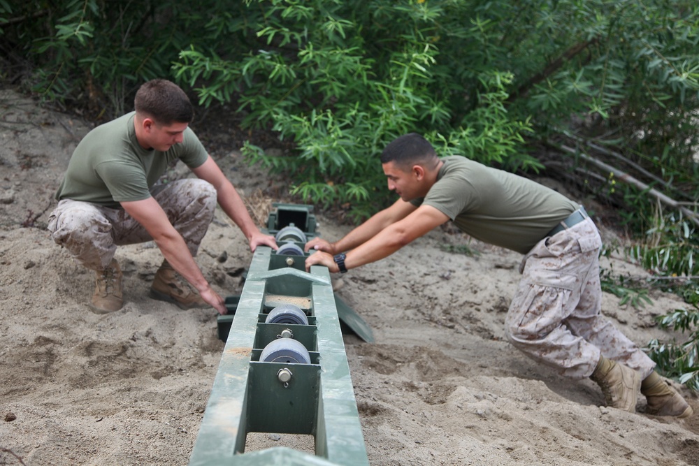 Combat engineers build bridge over muddy water for World Famous Mud Run