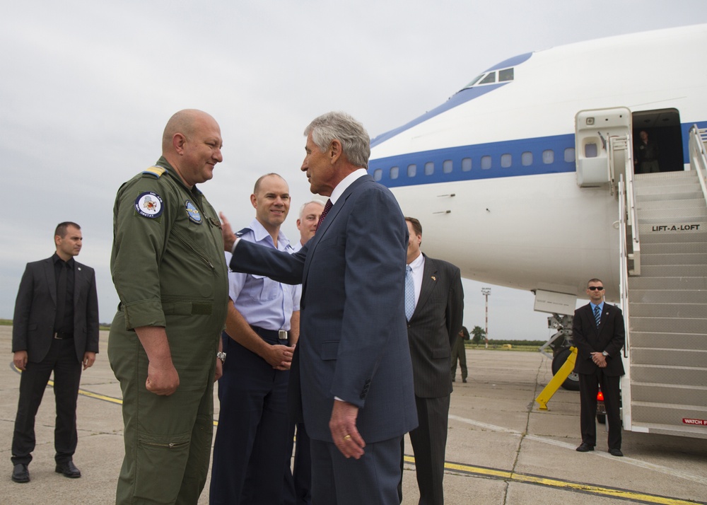 US Secretary of Defense Chuck Hagel (right) greets Romanian Air Force Col. Adrian Vasile