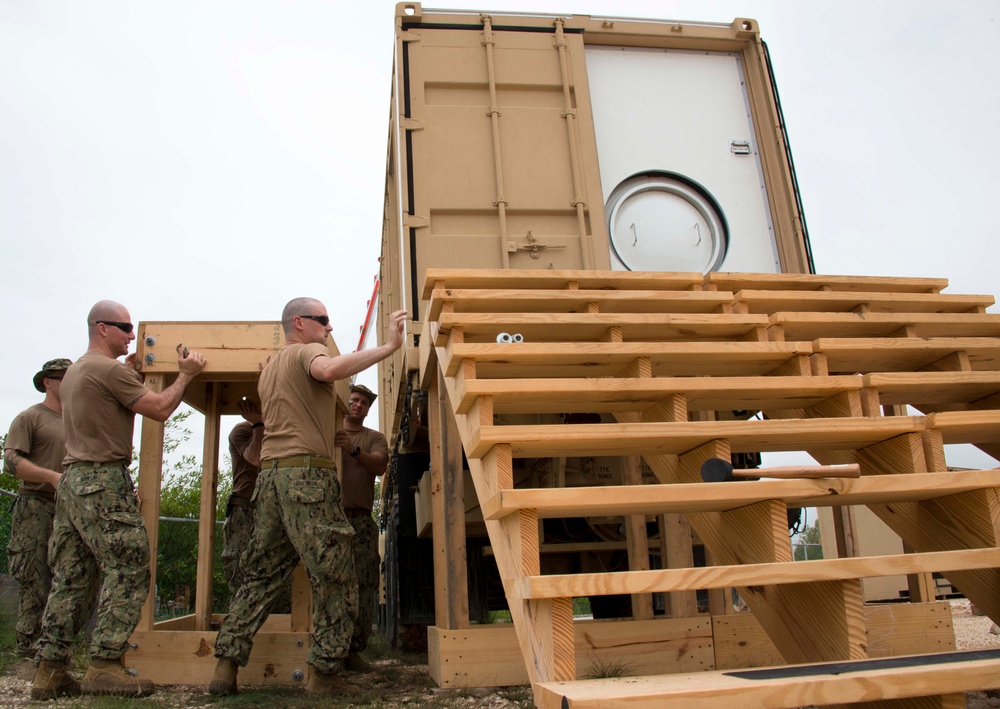 US Navy divers work on a mobile recompression chamber in Belize