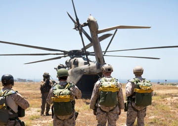 Marines jump off of Super Stallions for parachute operations