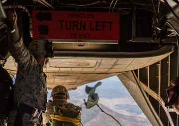 Marines jump off of Super Stallions for parachute operations