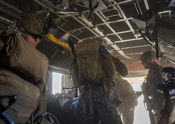 Marines jump off of Super Stallions for parachute operations