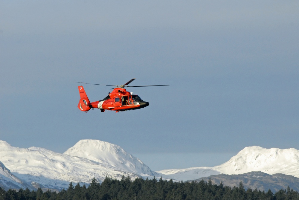 Coast Guard MH-65 Dolphin helicopter crew arrives at Spruce Cape near Kodiak, Alaska