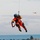Coast Guard MH-65 Dolphin helicopter crew conducts vertical surface training hoist operation in Kodiak, Alaska