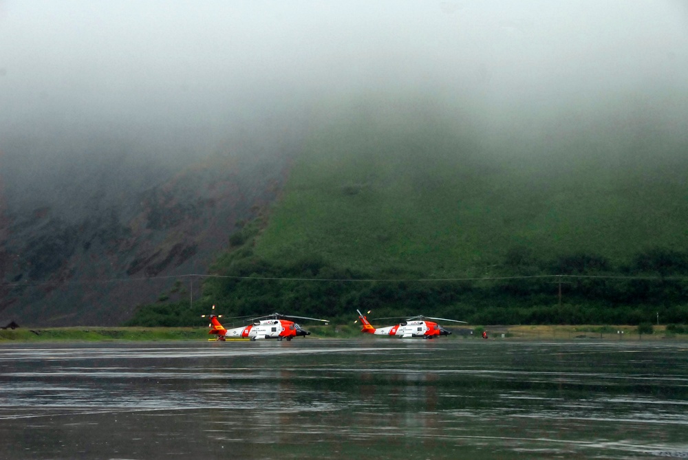 Coast Guard MH-60 Jayhawk helicopters stand ready for deployment on the flight line in Kodiak, Alaska