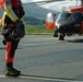 A Coast Guard aviation survival technician and MH-60 Jayhawk helicopter crew returns from a training flight in Kodiak, Alaska