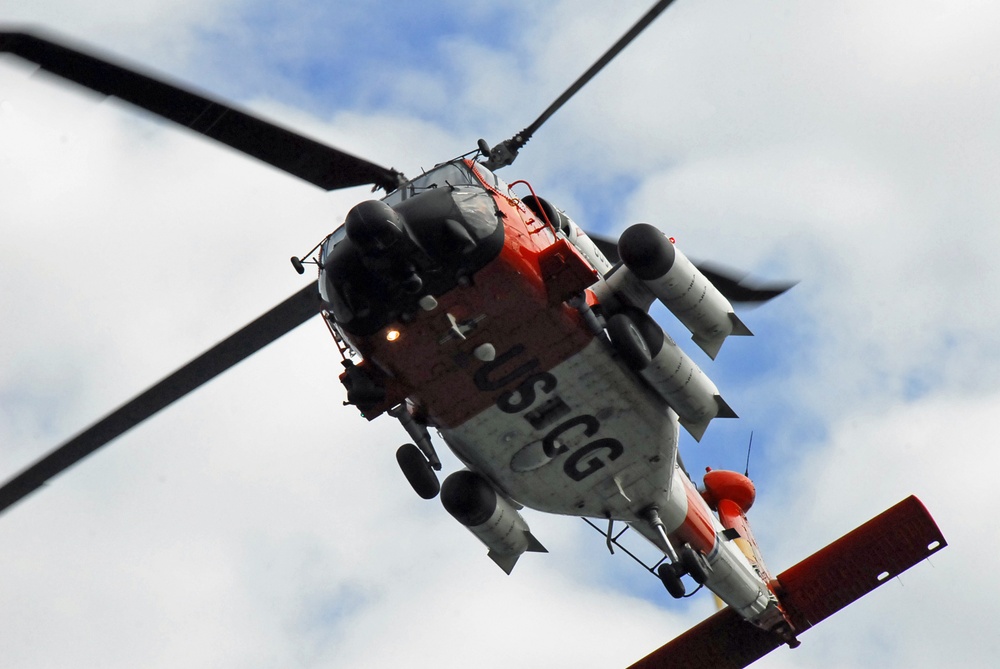 Coast Guard MH-60 Jayhawk helicopter crew takes off from Air Station Kodiak, Alaska
