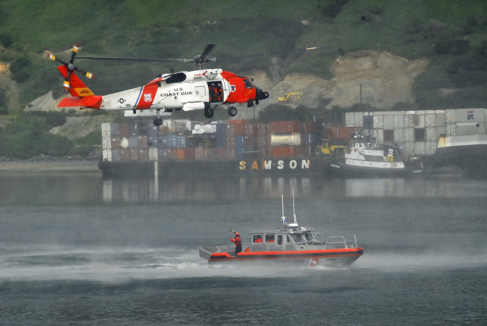 Coast Guard MH-60 Jayhawk helicopter crew conducts a hoist demonstration in Kodiak, Alaska