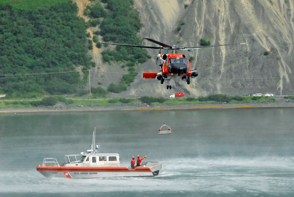 Coast Guard MH-60 Jayhawk helicopter crew conducts a hoist demonstration in Kodiak, Alaska