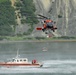 Coast Guard MH-60 Jayhawk helicopter crew conducts a hoist demonstration in Kodiak, Alaska