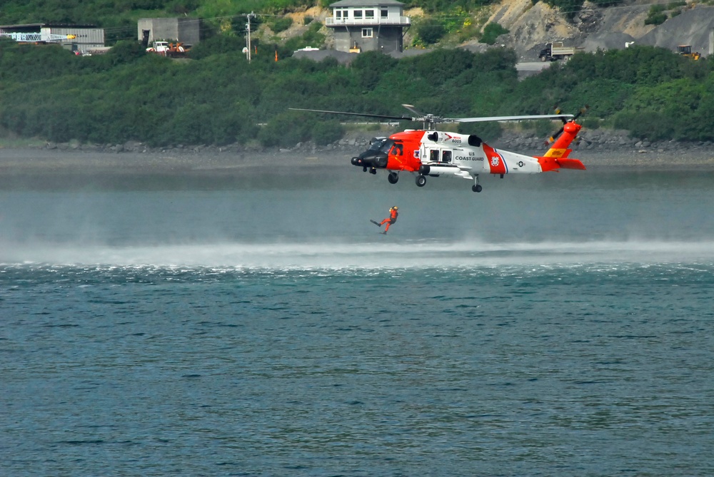 Coast Guard MH-60 Jayhawk helicopter crew deploys an aviation survival technician in Kodiak, Alaska