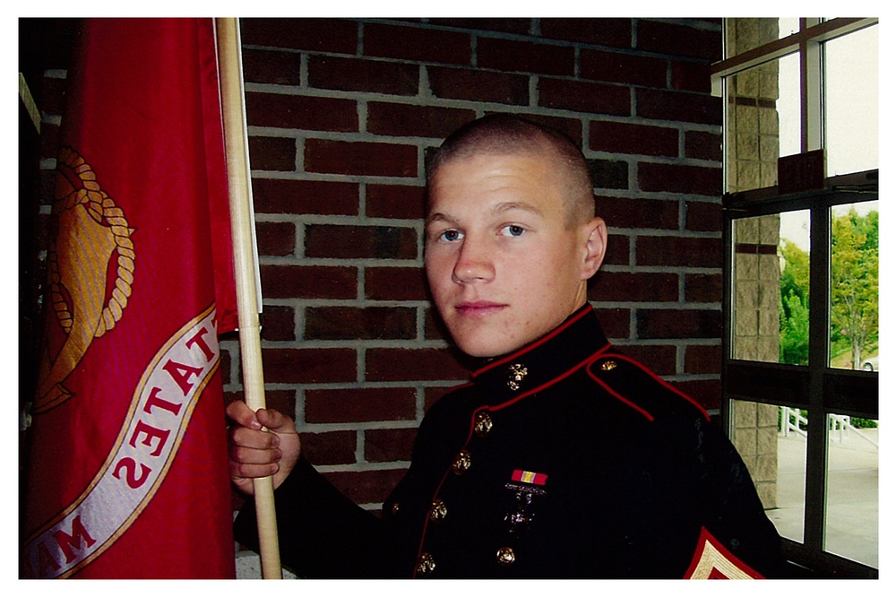 Pfc. Kyle Carpenter holds guidon.