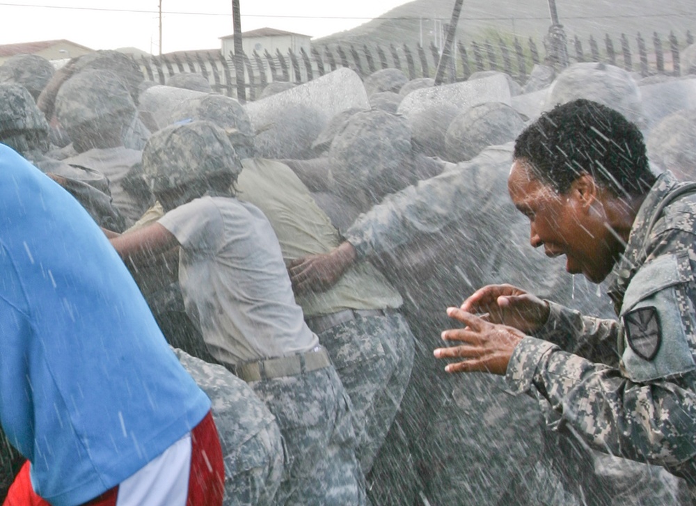 Sgt. Maj. Miller endures the ongoing spray of water during Operation Forward Guardian II