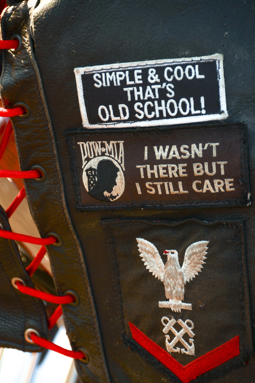 Patches, including one showing his Navy rating badge and rank, adorn the motorcycle vest of Fire Department Battalion Chief John 'Johnny Mac' McDonald
