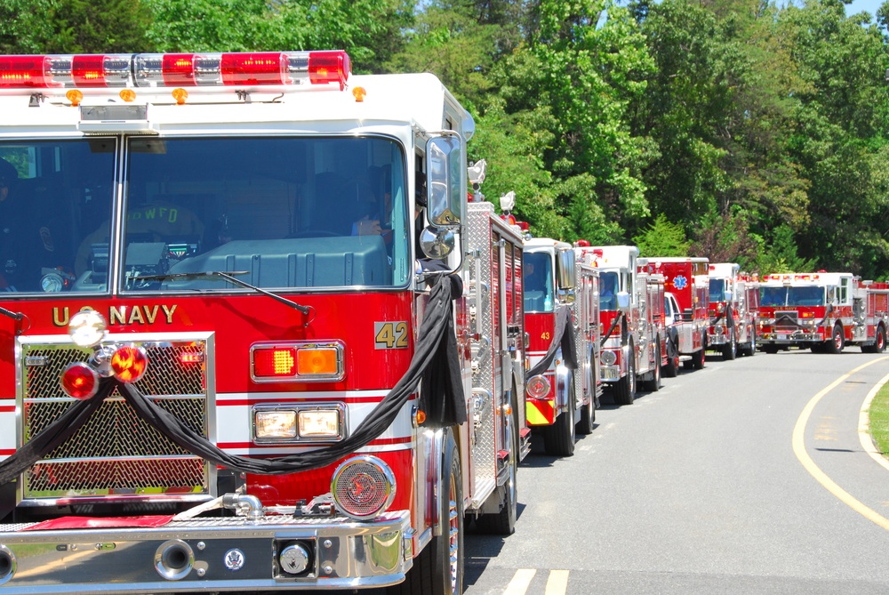 A large procession of fire trucks