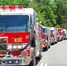 A large procession of fire trucks