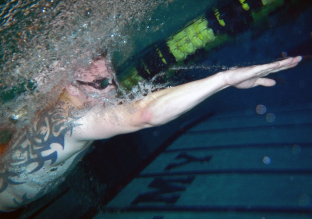 Lance Cpl. Fellows, US Marines, Warrior Transition Battalion, swims through the practice lane at the 2014 Warrior Trials