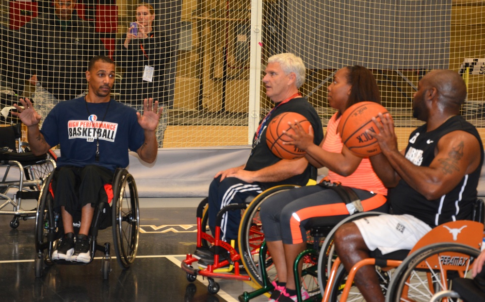 Wheelchair basketball coaches demonstrate ball-handling techniques at the 2014 Warrior Trials