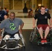 Wheelchair basketball coach shares tips to a player during training at the 2014 Warrior Trials