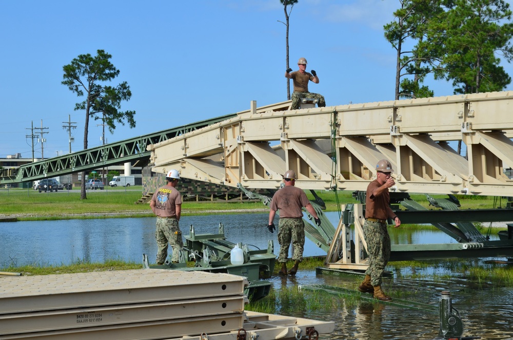 Seabees assemble a medium girder bridge