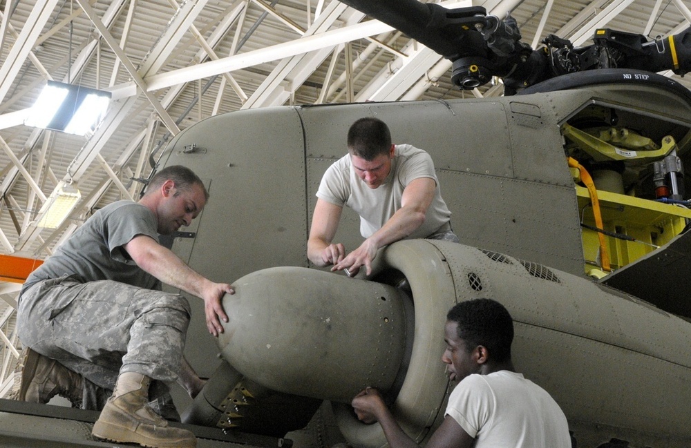 Soldiers install engine cowling on CH-47F Chinook Helicopter