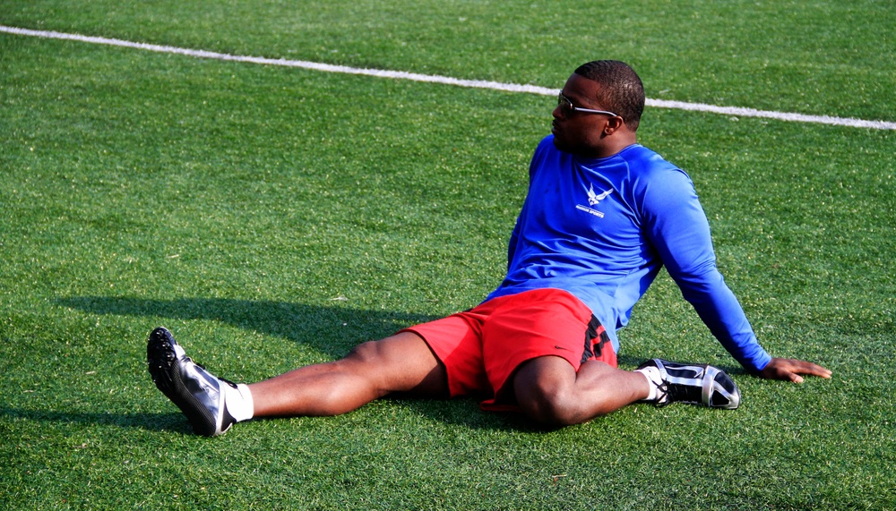 Air Force Staff Sgt. Sanders stretches his leg muscles before competing in the 2014 U.S. Army Warrior Trials