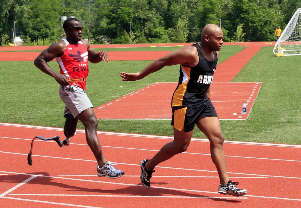 Athletes pass the baton in the 1,500 meter relay race during the 2014 Warrior Trials