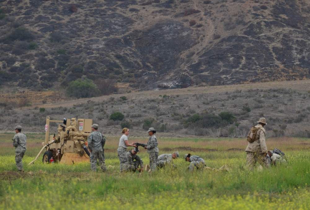 Soldiers and Marines work together to assemble fuel pumping stations
