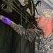 Spc. Sean Walton, preventive medicine specialist from the 787th Medical Detachment, New Orleans, collects water from the showers for testing