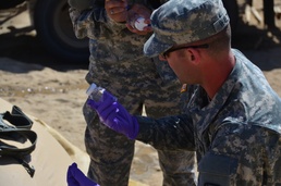 Spc. Sean Walton from the 787th Medical Detachment from New Orleans, collecting samples of purified water from the Reverse Osmosis Water Purification Unit
