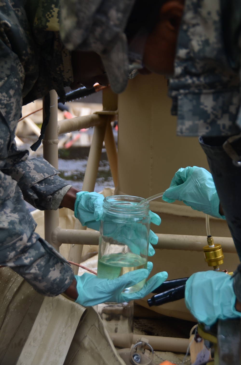 Soldiers from 418th Quartermaster Battalion are taking samples of fuel for testing
