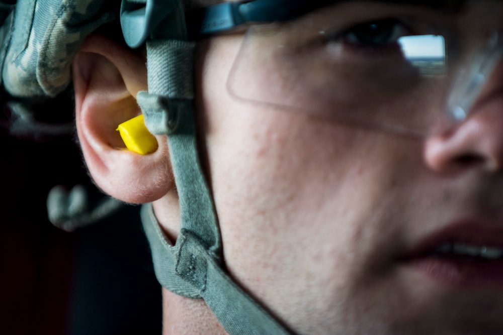 Soldier wearing hearing protection while riding on a CH-47 Chinook helicopter 