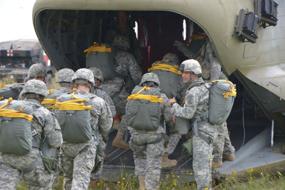 173rd Airborne Brigade lands after a jump June 19, 2014 from a 12th Combat Aviation Brigade CH-47 Chinook helicopter at Juliet Drop Zone in Pordenone, Italy