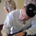 Cpl. Kyle Carpenter signs his name with the greats