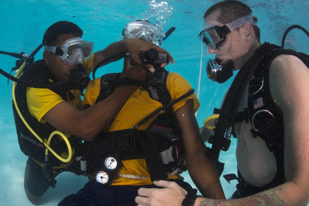 US Navy divers and Belizean Coast Guard divers practice SCUBA emergency procedures in a pool