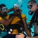 US Navy divers and Belizean Coast Guard divers practice SCUBA emergency procedures in a pool